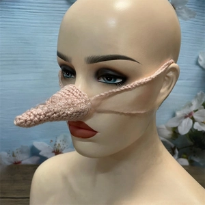 Close-up of handmade pink knitted animal nose warmer with hanging ear straps for winter