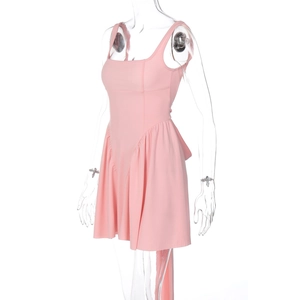 Detail of pink backless summer dress featuring tie-up straps and ruffled hem design