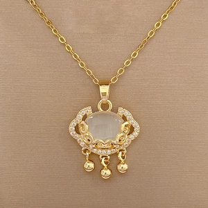 Close-up of golden cloud pendant necklace with white jade and tiny crystals