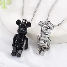Detailed view of silver and black bear pendants on sleek titanium steel necklaces