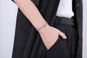 Detailed view of silver stainless steel chunky chain bracelet with OT clasp on wrist