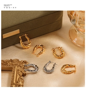 Detailed view of U-shaped twisted hoop earrings in gold and silver plating