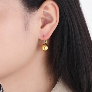 Minimalist 18k gold plated stainless steel ball drop earrings worn on model's ear