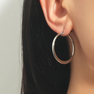 Silver stainless steel large hoop earring worn by a model to show size and fit
