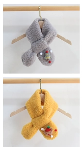 Close-up of children's plush scarves in grey and yellow with cute cartoon appliques