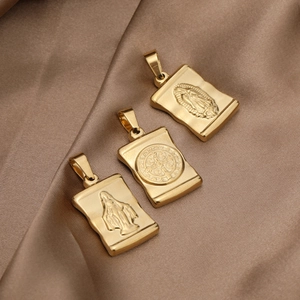 Vintage gold stainless steel rectangular religious cross pendants on silk background