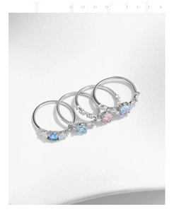Detailed view of s925 sterling silver crown rings with blue, pink, and opal gemstone inserts