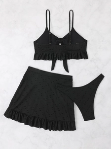Detail of black eyelet embroidery fabric on 3-piece bikini set with ruffle skirt