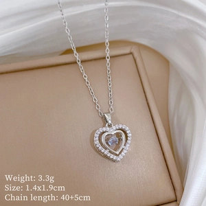 Macro shot of silver titanium heart necklace with dimensions on silk background