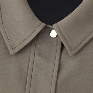 Taupe bomber jacket with pleated hem featuring a gold button and twill texture detail
