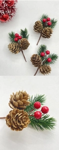 Macro detail of Christmas pine cone picks with red berries and green pine needles