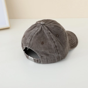 Détail de la boucle en métal réglable et du tissu délavé vintage de la casquette