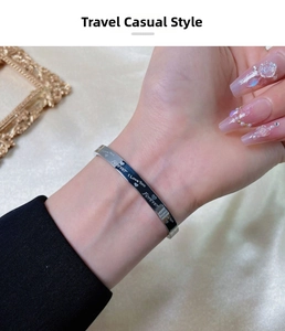 Close-up of silver steel bangle featuring Forever and I Love You engraved inscriptions