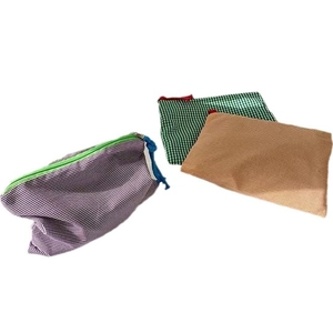 Three-piece checkered fabric makeup bag set with zip closure in purple green and orange
