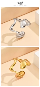 Detailed macro view of gold and silver irregular wave open rings with polished finish