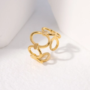 Close-up of golden geometric adjustable ring with interlocking oval links on white stand