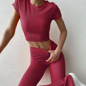 Dettaglio del tessuto a maglia a coste rosso rosa su un set di top e pantaloni a zampa