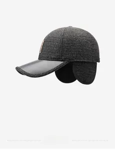 Close-up of winter baseball cap with foldable ear flaps and dark grey wool fabric texture