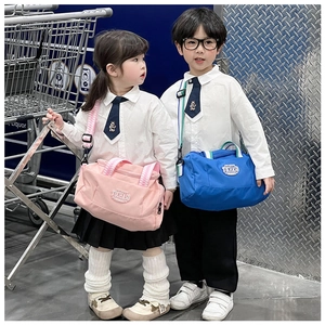 Pink and blue children's sports shoulder bags worn by kids in a stylish urban setting