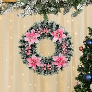 Detailed view of pink glitter flowers and berries on a snowy Christmas wreath