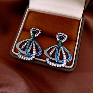 Détail de boucles d'oreilles vintage en forme d'éventail avec zircons colorés