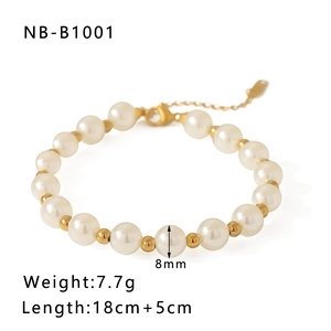 Detail of 18k gold plated beads and 8mm pearls on a baroque style bracelet with chain