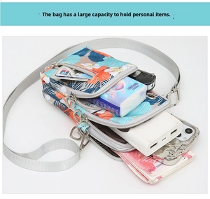 Detailed internal view showing three compartments of the floral Oxford cloth crossbody bag