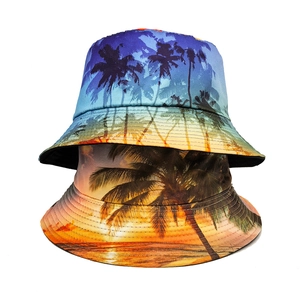 Close-up of bucket hat with tropical sunset and palm tree print on white background