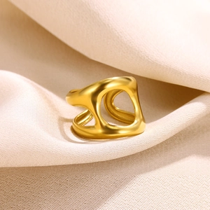 Detailed view of an 18k gold plated stainless steel ring with fluid hollow cut-outs