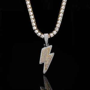 Macro shot of two-tone hip hop lightning pendant with zircon stones on a tennis chain
