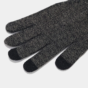 Detailed macro view of gray knitted touchscreen gloves with specialized conductive fingertips