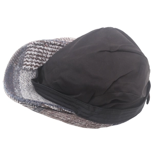 Detail view of newsboy cap showing black cotton lining and thick wool tweed fabric texture
