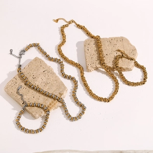 Detailed view of 18K gold and silver two-tone stainless steel necklaces and bracelets
