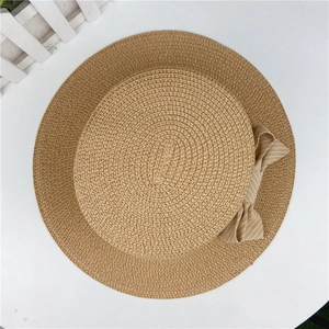 Flat top straw sun hat in light brown with a striped bow accent on a white background