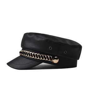 Black faux leather newsboy cap with gold metal chain accent and textured alligator finish