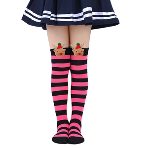Detailed view of striped Christmas stockings with plush reindeer dolls and red festive hats