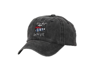 Detail of embroidered SURF WAVE logo on washed black cotton sports baseball cap