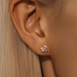 Macro shot of S925 silver butterfly earrings with pink and purple zircon stones on ear