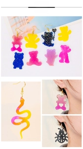 Detailed view of colorful resin animal earrings including bear and butterfly charms