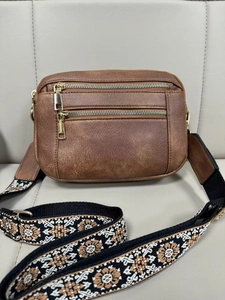 Detail of retro brown PU crossbody bag with triple zippers and floral ethnic strap