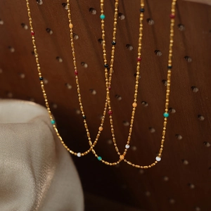 Minimalist gold plated titanium steel necklaces with colorful enamel beads on wood