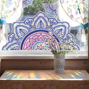 Rainbow mandala window film creates colorful prism light effects on interior surfaces