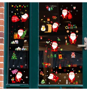 Weihnachtliche Fensteraufkleber mit Weihnachtsmann und Schneemann auf grüner Glastür