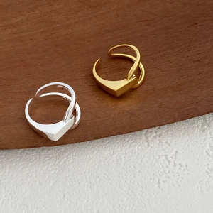 Detail of minimalist S925 silver asymmetric geometric open rings in gold and silver