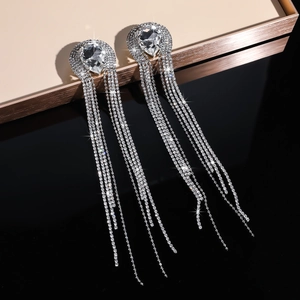 Macro shot of silver tassel earrings with crystal rhinestones and large teardrop stones