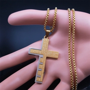Detail of cross pendant featuring engraved Lord's Prayer on two-tone gold and silver metal