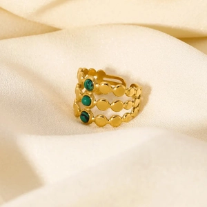 Gold-plated layered ring with triple green malachite stones on a satin background