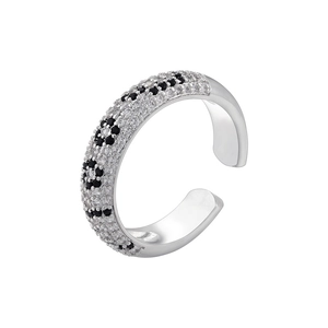 Detail of silver ear cuff with black and clear stones in floral pattern on white background
