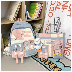 Detail of color-block backpack and shoulder bag set with cute cartoon accessories