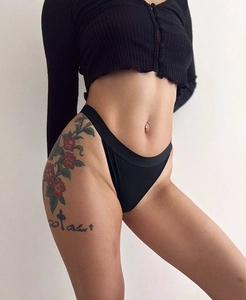Detailed side view of basic black breathable cotton underwear on a female model